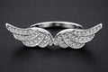 Silver angel wings statement ring with cubic zirconia stones and detailed feather design