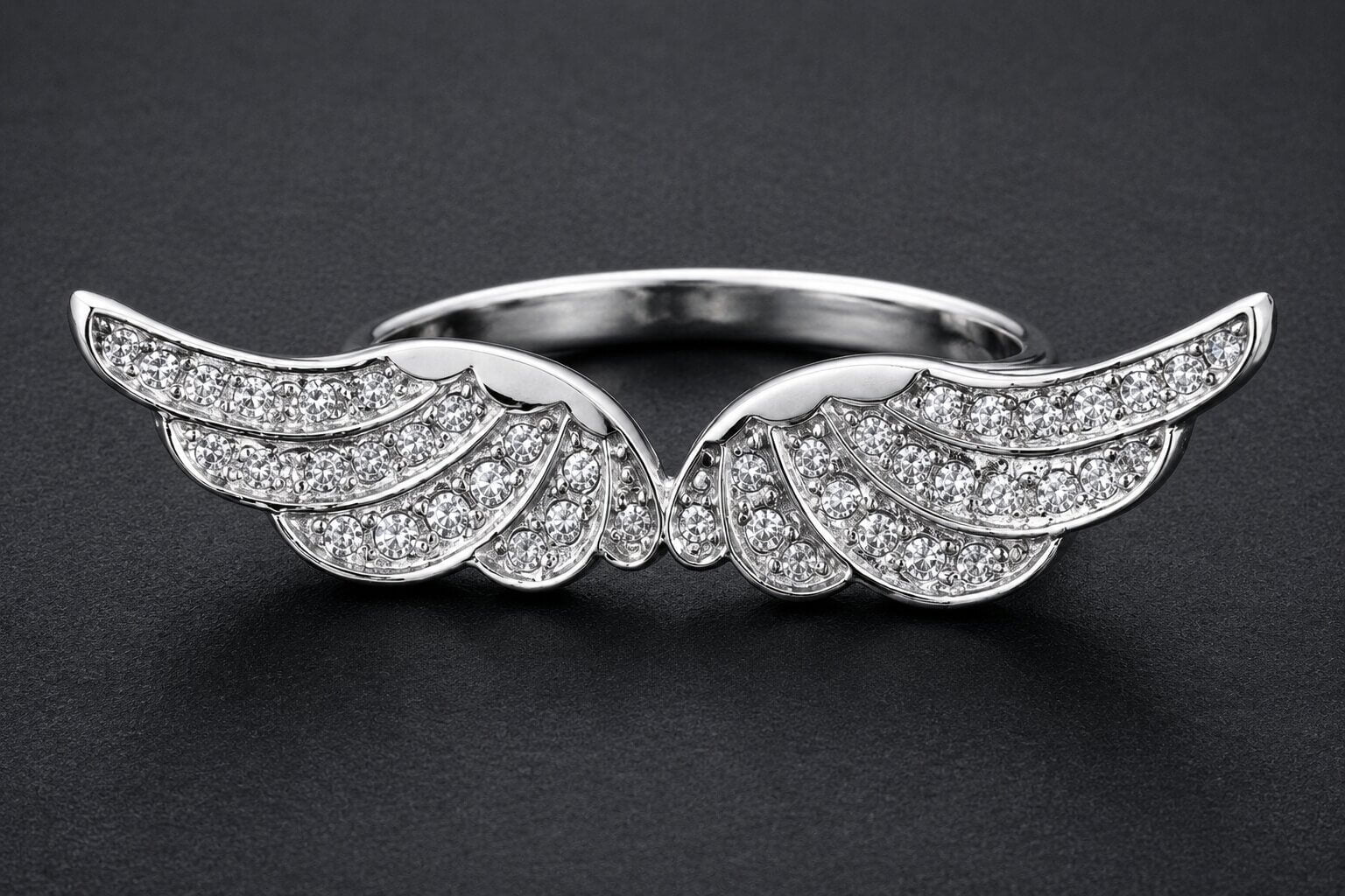 Silver angel wings statement ring with cubic zirconia stones and detailed feather design