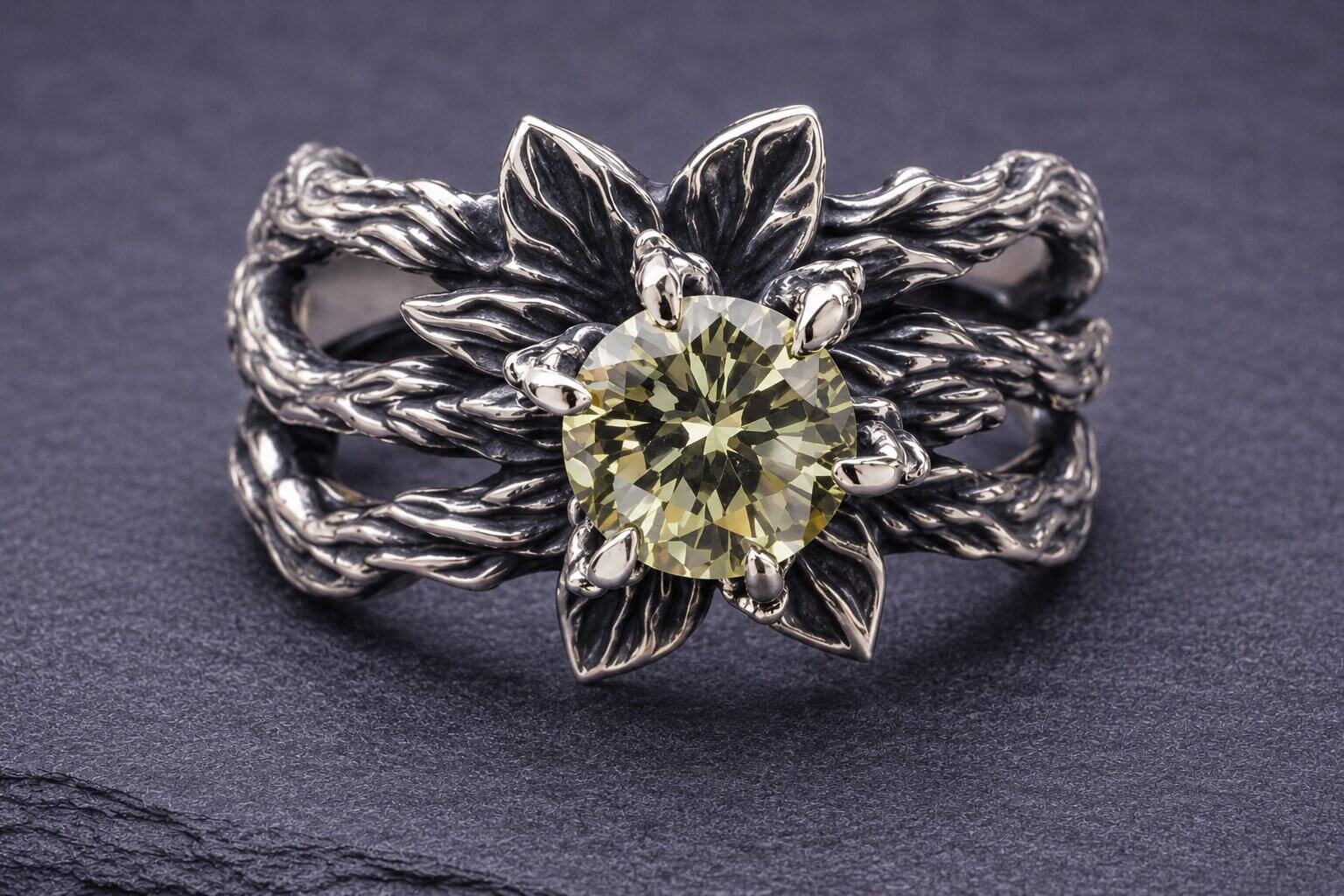 Silver flower ring with peridot gemstone center and layered petal design with detailed leaves