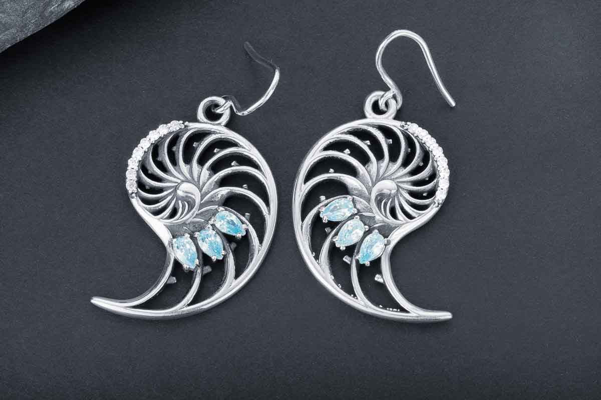 Silver nautilus shell earrings with aquamarine stones and spiral design