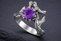 Sterling silver branch ring with round purple cubic zirconia cradled in detailed oxidized branch design