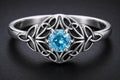 Sterling silver Celtic knot ring with blue cubic zirconia center stone and intricate knotwork design