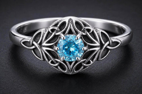 Sterling silver Celtic knot ring with blue cubic zirconia center stone and intricate knotwork design