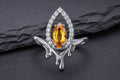 Sterling silver flame halo ring with yellow cubic zirconia center stone and white cubic zirconia halo