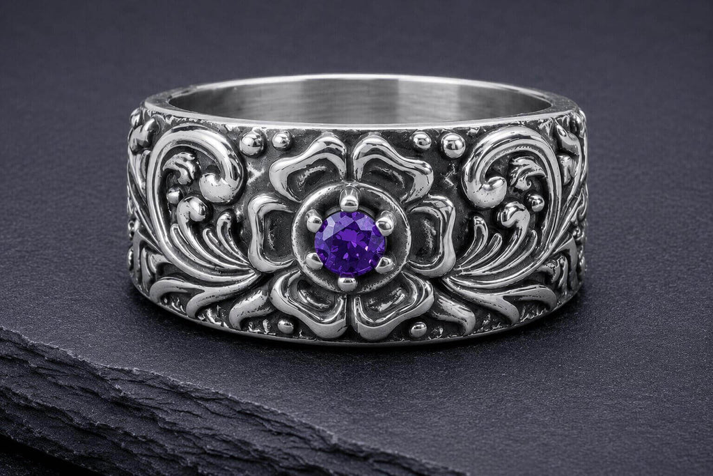 Silver floral band ring with purple cubic zirconia stone surrounded by detailed ornamental vine and floral patterns