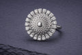 Sterling silver mandala ring with domed center and cubic zirconia accent stones in intricate geometric lattice pattern