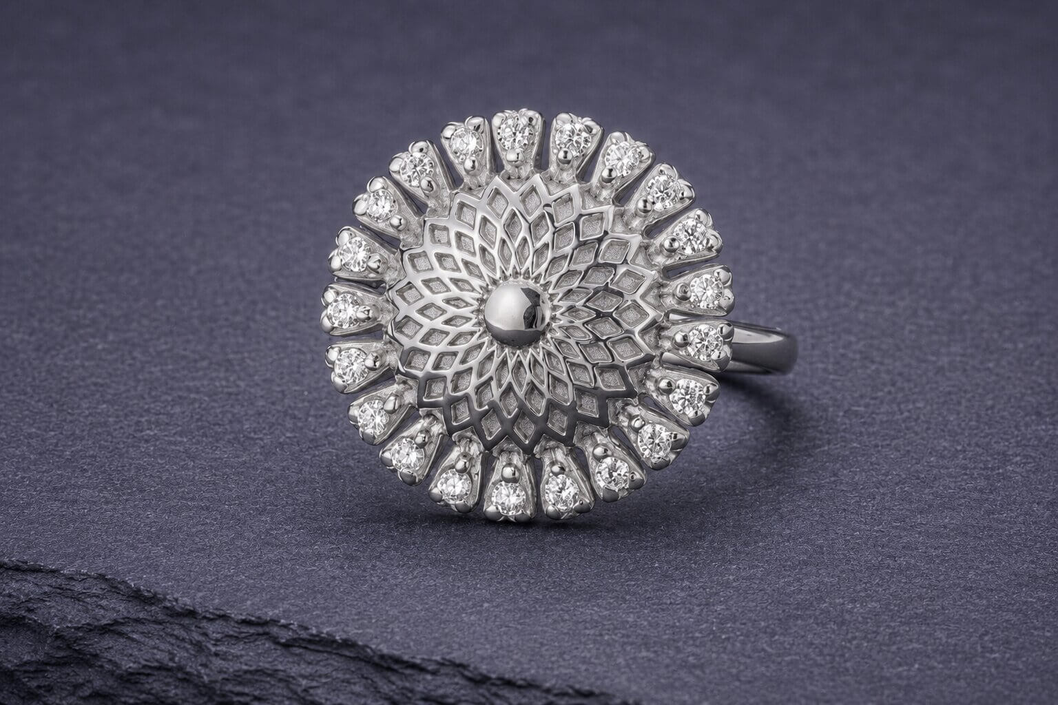Sterling silver mandala ring with domed center and cubic zirconia accent stones in intricate geometric lattice pattern