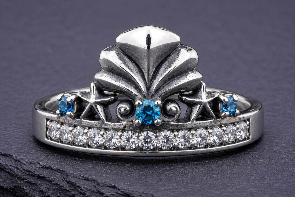 Sterling silver mermaid crown ring with blue and white cubic zirconia stones and ornate seashell centerpiece