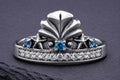Sterling silver mermaid crown ring with blue and white cubic zirconia stones and ornate seashell centerpiece