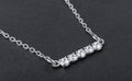Sterling silver bar necklace with five round cubic zirconia stones