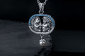 Sterling silver lovers kiss necklace with blue stones and pearl drop