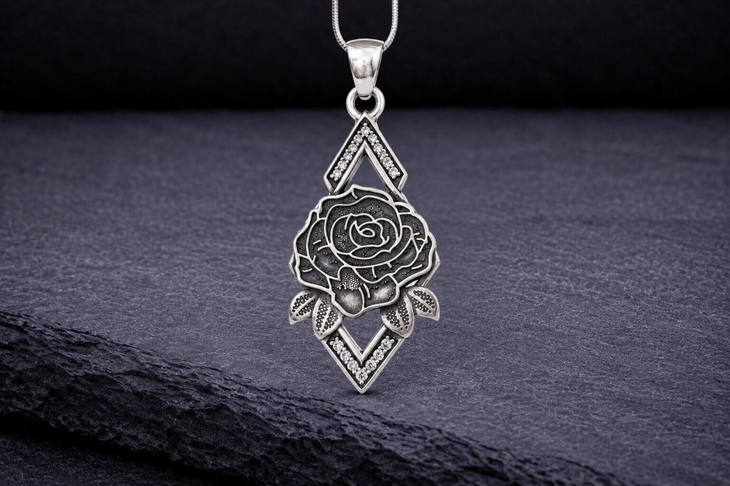 Sterling silver rose pendant necklace with diamond shaped frame and leaves
