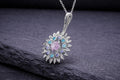 Sterling silver sunflower pendant necklace with pink center stone and blue gemstone accents