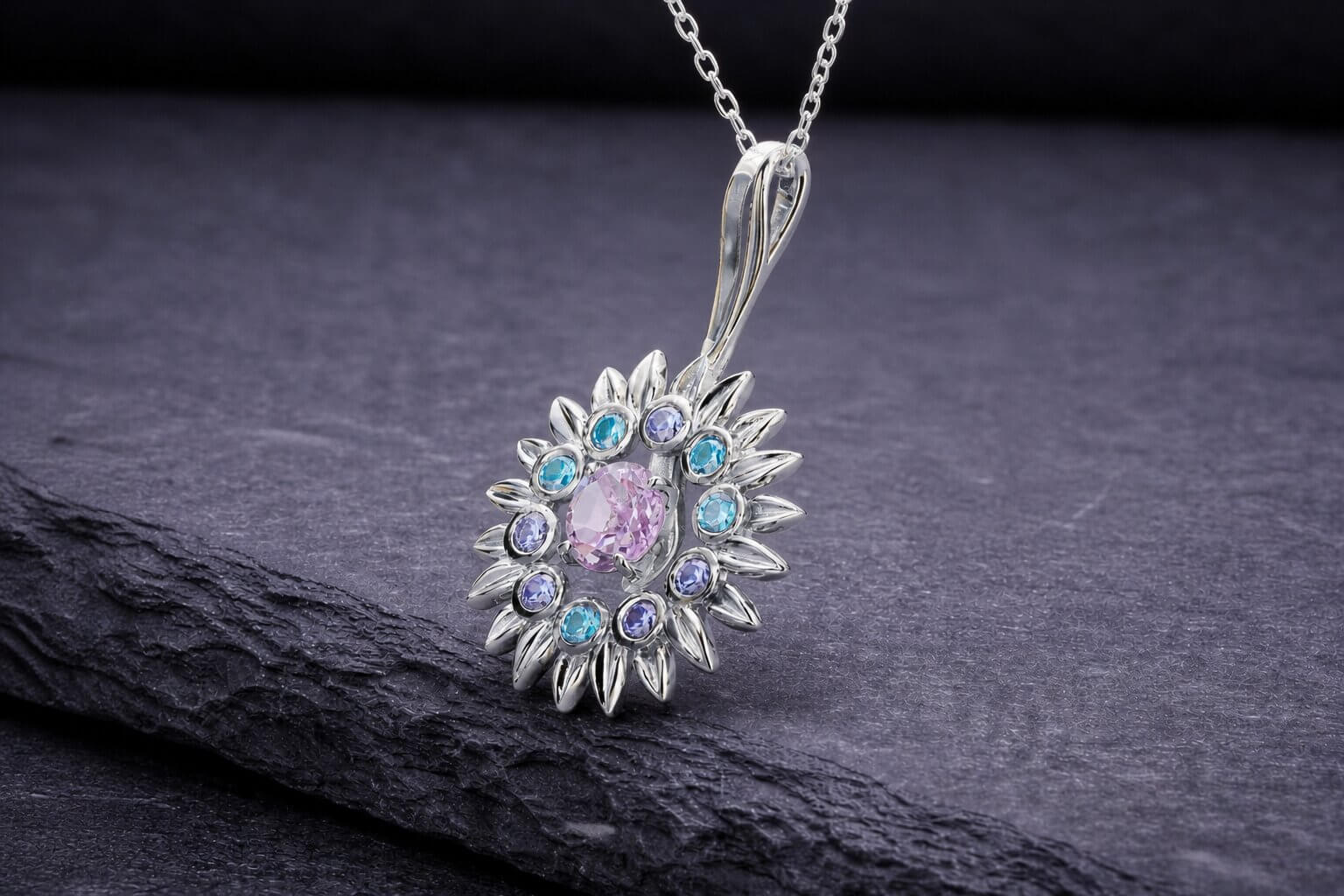 Sterling silver sunflower pendant necklace with pink center stone and blue gemstone accents