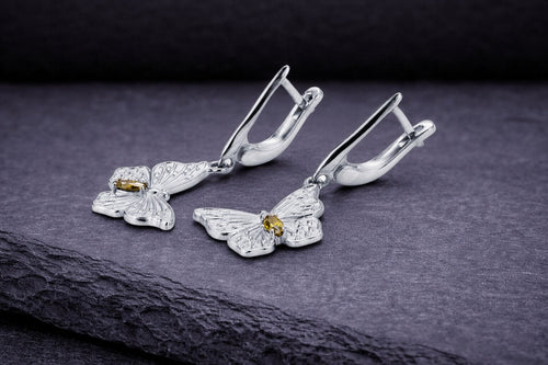 Sterling silver butterfly drop earrings with golden cubic zirconia stones and detailed wing design