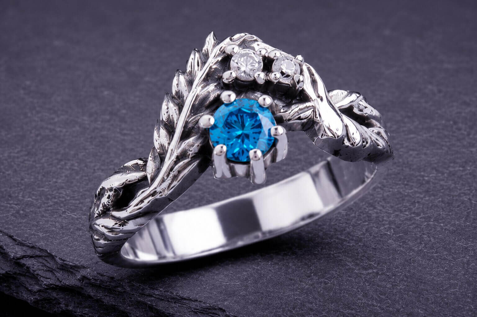 Sterling silver leaf ring with blue cubic zirconia stone and accent details