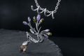 Sterling silver vine branch pendant necklace with purple, green, and golden cubic zirconia stones